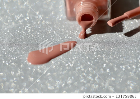 Beige pink nail polish with glitter Beige pink nail polish with glitter 131759865