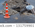Construction site for laying of underground utilities using the technology of horizontal directional drilling under asphalt. Black plastic pipe made of low-pressure polyethylene sticks out of ground 131759901