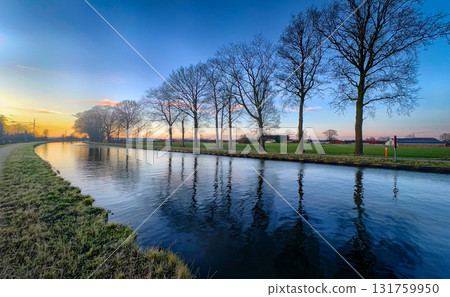A Serene Sunset Reflection Glimmering Across a Tranquil and Peaceful River Landscape A Serene Sunset Reflection Glimmering Across a Tranquil and Peaceful River Landscape 131759950