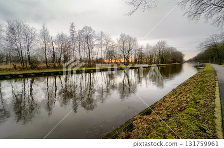A Serene Sunset Reflection Over a Tranquil Canal Landscape, Embracing Natures Beauty A Serene Sunset Reflection Over a Tranquil Canal Landscape, Embracing Natures Beauty 131759961