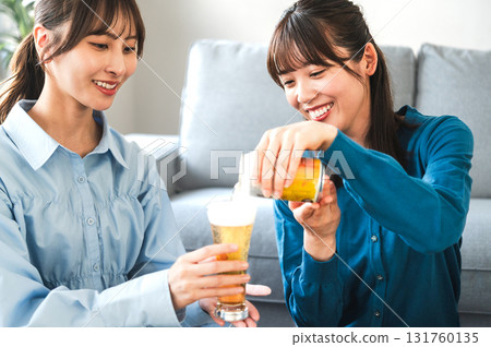 A woman poured beer 131760135