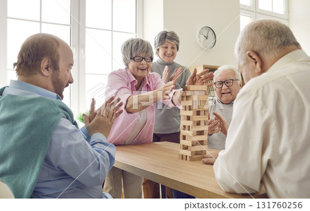 Group of happy senior people having fun and playing board games in retirement home Group of happy senior people having fun and playing board games in retirement home 131760256