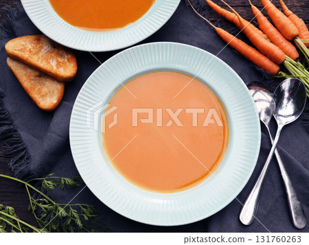 Carrot cream soup on rustic wooden table. Autumn cream soup with croutons. Top view. 131760263