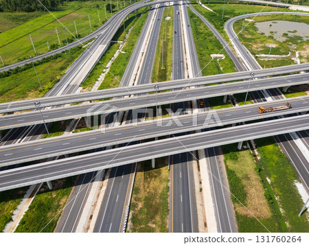 Drone shot a large highway interchange crossing over green farmlands in Thailand 131760264