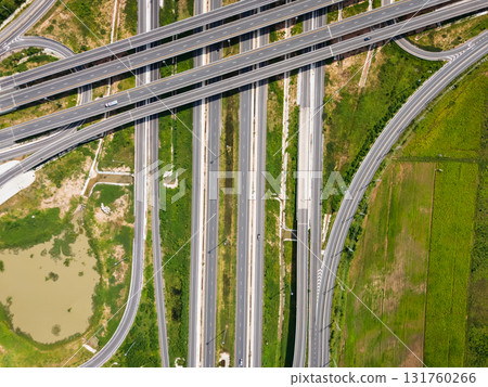 Drone shot a large highway interchange crossing over green farmlands in Thailand 131760266