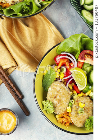 Buddha bowl with vegetables and fish cutlets. 131760487
