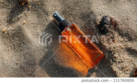 Sunlit spray bottle on beach sand Sunlit spray bottle on beach sand 131760809