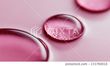 Droplets of pink liquid on a surface Droplets of pink liquid on a surface 131760818