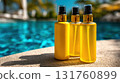 Bright yellow bottles beside a pool 131760899