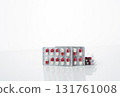 Red and white antibiotic capsule pill in blister pack. Prescription drug clindamycin 300 mg for bacterial infection treatment healthcare and pharmaceutical use. Healthcare and medicine industry. 131761008