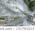 Aerial view of granite and limestone crushing plant with dump trucks and excavators processing raw stone into construction aggregates for concrete and infrastructure development. Stone mill factory. 131761013