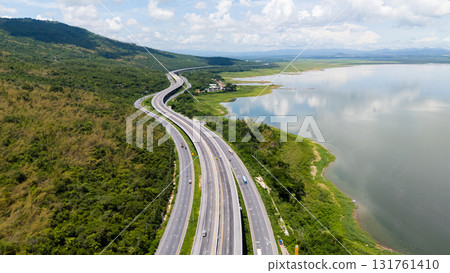 Drone shot The M6 motorway Nakhon Ratchasima Province - Bang Pa-in Lam Ta Khong River and Mountain. Motorway Korat Thailand Drone shot The M6 motorway Nakhon Ratchasima Province - Bang Pa-in Lam Ta Khong River and Mountain. Motorway Korat Thailand 131761410