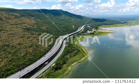 Drone shot The M6 motorway Nakhon Ratchasima Province - Bang Pa-in Lam Ta Khong River and Mountain. Motorway Korat Thailand Drone shot The M6 motorway Nakhon Ratchasima Province - Bang Pa-in Lam Ta Khong River and Mountain. Motorway Korat Thailand 131761412