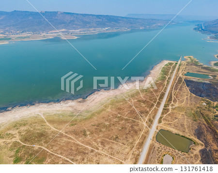 Lam ta khong Nakhon Ratchasima Thailand. An aerial perspective captures a tranquil river, winding paths, and small ponds. The landscape reflects nature's beauty and tranquility during daylight Lam ta khong Nakhon Ratchasima Thailand. An aerial perspective captures a tranquil river, winding paths, and small ponds. The landscape reflects nature's beauty and tranquility during daylight 131761418