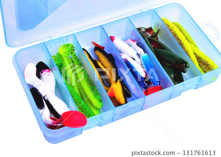 Box for fishing accessories with silicone baits inside on a white background close-up Box for fishing accessories with silicone baits inside on a white background close-up 131761613