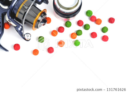Fishing coil, colored boilies, braided cord, on white background, close-up Fishing coil, colored boilies, braided cord, on white background, close-up 131761626