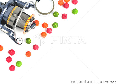 Fishing coil, colored boilies, braided cord, on white background, close-up Fishing coil, colored boilies, braided cord, on white background, close-up 131761627