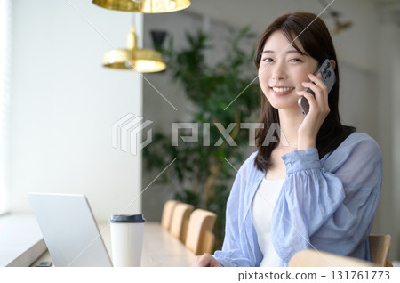 有一個智能手機的一名婦女在咖啡館 131761773