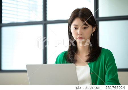 一位身著辦公室休閒服的女士在筆記型電腦上工作 一位身著辦公室休閒服的女士在筆記型電腦上工作 131762024