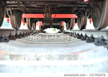 Old railway locomotive, bottom view, standing on rails 131762078