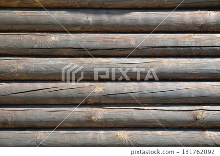 background from wooden natural logs of round brown color lit by the sun background from wooden natural logs of round brown color lit by the sun 131762092