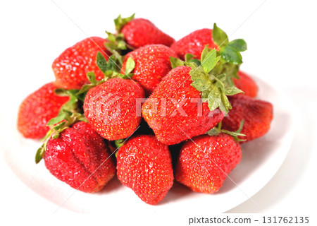 red big strawberries in a white plate on a white background with water drops on berries isolate red big strawberries in a white plate on a white background with water drops on berries isolate 131762135