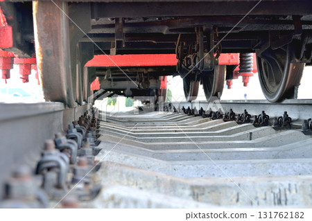 Old railway locomotive, bottom view, standing on rails 131762182