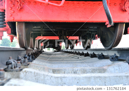 Old railway locomotive, bottom view, standing on rails Old railway locomotive, bottom view, standing on rails 131762184