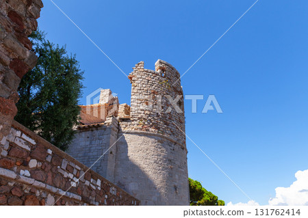 Cannes, France. A tall stone tower rises above weathered fortress walls 131762414