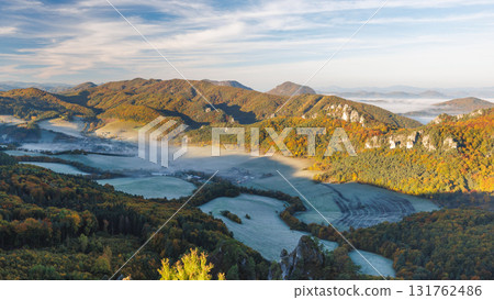 Scenic mountain landscape featuring misty valleys, autumn forests, and striking rock formations under a beautiful, clear sky. The Sulov Rocks, national nature reserve in northwest of Slovakia, Europe. Scenic mountain landscape featuring misty valleys, autumn forests, and striking rock formations under a beautiful, clear sky. The Sulov Rocks, national nature reserve in northwest of Slovakia, Europe. 131762486
