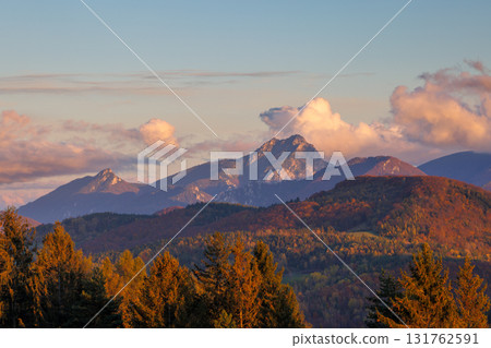 Mountainous landscape at dawn with warm sunlight illuminating forests and clouds, creating a peaceful view. The Mala Fatra national park in Slovakia, Europe. Mountainous landscape at dawn with warm sunlight illuminating forests and clouds, creating a peaceful view. The Mala Fatra national park in Slovakia, Europe. 131762591