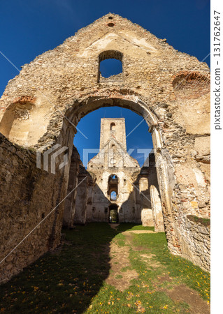 The Katarinka, ruins of a Franciscan monastery and church in Slovakia, Europe. Ruined building shows weathering of walls and tower in an old architectural landscape against a blue sky The Katarinka, ruins of a Franciscan monastery and church in Slovakia, Europe. Ruined building shows weathering of walls and tower in an old architectural landscape against a blue sky 131762647