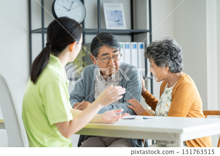 Senior couple consulting with care manager Senior couple consulting with care manager 131763515