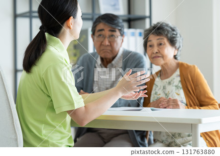 Senior couple consulting with care manager 131763880