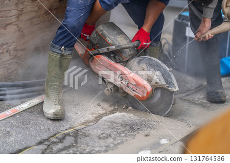 Plumbing work - Concrete cutter - Wet type uses water spray to prevent dust from scattering and cool frictional heat Plumbing work - Concrete cutter - Wet type uses water spray to prevent dust from scattering and cool frictional heat 131764586