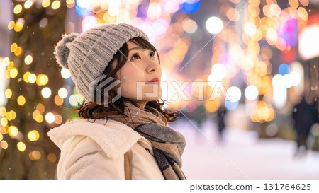 Woman watching snow in a townscape. Text space. Background material. 16:9 size. AI-generated material. 131764625