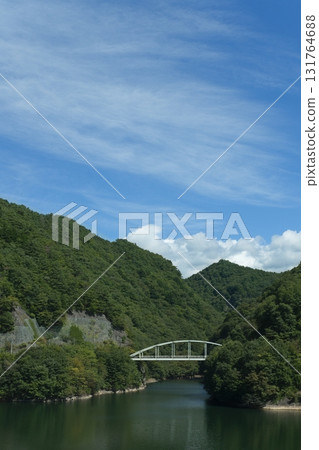Masutomi Ohashi, a white arch bridge spanning Lake Mizugaki Masutomi Ohashi, a white arch bridge spanning Lake Mizugaki 131764688