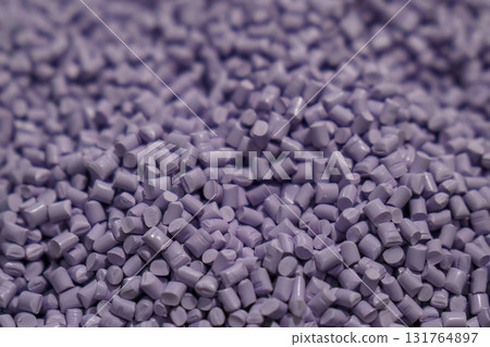 The pile of violet pellets materials for plastic injection process. 131764897