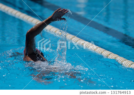 Man swims the crawl in the swimming pool 131764913