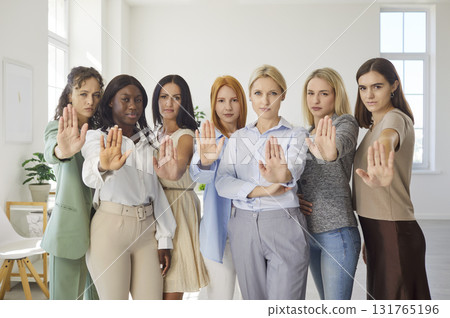 Confident women together with raised palms, unified stop gesture and boundaries Confident women together with raised palms, unified stop gesture and boundaries 131765196