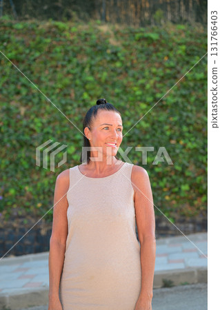 Portrait of a beautiful middle aged Scandinavian woman smiling and looking away Portrait of a beautiful middle aged Scandinavian woman smiling and looking away 131766403