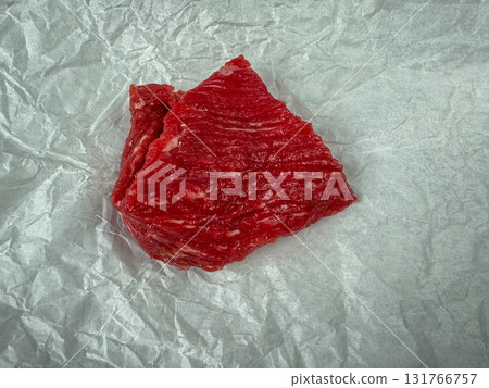 Raw beef steak on parchment paper, top view food background with copy space Raw beef steak on parchment paper, top view food background with copy space 131766757