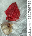 Raw beef cuts with garlic on crumpled parchment, top view cooking ingredients 131766759