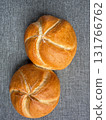 Two golden Kaiser rolls on linen background, top view bakery mockup with copy space 131766762