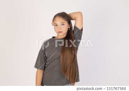 Woman is posing for a photo with her right hand behind her head Woman is posing for a photo with her right hand behind her head 131767368