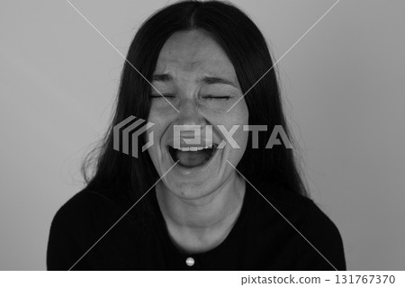 Woman in deep laughter, eyes shut, mouth wide open. Woman in deep laughter, eyes shut, mouth wide open. 131767370