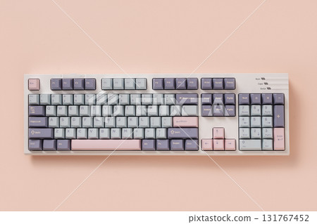 Modern mechanical keyboard on light pink background. Minimal style and design keyboard. Custom build keyboard. Colorful pastel creamy pink and green key cap. Top view. Modern mechanical keyboard on light pink background. Minimal style and design keyboard. Custom build keyboard. Colorful pastel creamy pink and green key cap. Top view. 131767452