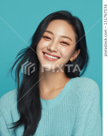 Woman with long dark hair smiling brightly against a light blue background during a cheerful indoor photoshoot 131767538