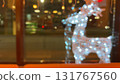 glowing figures of deer near the house, Christmas lights, defocused bokeh 131767560