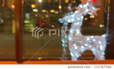 glowing figures of deer near the house, Christmas lights, defocused bokeh glowing figures of deer near the house, Christmas lights, defocused bokeh 131767560